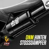 A close-up of a bicycle's rear shock absorber with branding and text overlays. Produktbild-Vorschau