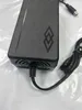 A close-up shot of a black power adapter with cables. Podgląd zdjęcia produktu