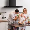 A family is in a kitchen, with the father feeding donuts to their son. Náhľad obrázku produktu