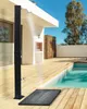 An outdoor shower is set up on a wooden deck next to a swimming pool. Náhľad obrázku produktu