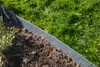 A close-up view of a garden bed edge made of galvanized steel, with soil and grass visible. Produktbild-Vorschau