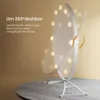 A makeup mirror with lights is shown on a table, with text highlighting its features. Produktbild-Vorschau
