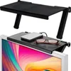 A black shelf sits on top of a computer monitor, holding a hard drive and a pair of glasses. Produktbild-Vorschau