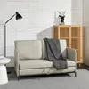 A modern living room scene with a sofa, lamp, and cabinet. Produktbild-Vorschau