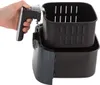 A hand is shown holding the handle of an air fryer basket, which is partially removed from the main unit. Produktbild-Vorschau