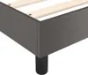 A close-up view of the corner of a bed frame, showing the dark gray upholstery and wooden slats. Produktbild-Vorschau