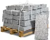 A pallet of granite stones with one stone placed in front. Produktbild-Vorschau