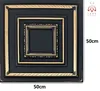 A square decorative panel with multiple concentric frames, featuring a black finish with gold accents. Produktbild-Vorschau