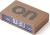 A close-up, angled view of a gold digital alarm clock with a blue display. Anteprima dell’immagine prodotto