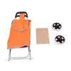 A shopping cart with its wheels and a cardboard piece laid out on a white background. Produktbild-Vorschau