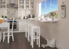 A bright, modern kitchen with a dining area by the window. Anteprima dell’immagine prodotto