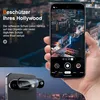 A hand holding a smartphone displaying a city at night, with a close-up of a phone camera lens protector in the foreground. Produktbild-Vorschau
