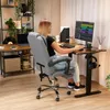 A woman is working at a standing desk in a home office setting. Produktbild-Vorschau