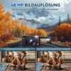 A digital camera is shown in a scenic landscape, with split images below comparing its camera quality to others, featuring children. Produktbild-Vorschau