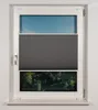 A window with a dark gray pleated blind partially covering it, showing a view of trees and sky. Produktbild-Vorschau