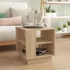 A wooden side table with books and cups on it, placed next to a sofa in a living room. Náhled obrázku produktu