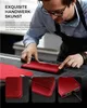 A person is crafting a red leather phone case. Produktbild-Vorschau