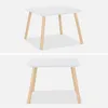 Two studio shots of a white square children's table with light wood legs against a plain background. Anteprima dell’immagine prodotto