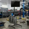 A computer trolley with a monitor and keyboard in a car repair workshop. Náhled obrázku produktu
