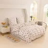 A bedroom scene with a bed made up with floral patterned bedding. Produktbild-Vorschau