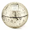 A round, gold-colored cosmetic jar with a textured surface and a white label. Voir les images du produit
