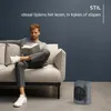 A man is reading a book on a couch next to a space heater. Voir les images du produit