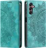 A teal flip case for a Samsung Galaxy S24 FE phone with a mandala pattern embossed on it, shown from the front and back. Produktbild-Vorschau