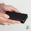 Hands holding a black power bank. Náhľad obrázku produktu