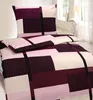 A bed with a duvet and pillow, both featuring a geometric pattern. Produktbild-Vorschau