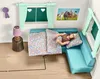 A dollhouse scene depicting a bedroom with a doll lying on a couch under a blanket. Produktbild-Vorschau