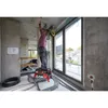 A construction worker is installing electrical wiring on the ceiling of a building under construction. Produktbild-Vorschau