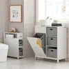 A bathroom scene with two white storage units, one with a laundry basket and the other with toilet paper and drawers. Náhled obrázku produktu