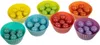Seven colorful silicone cupcake liners filled with small, round, colorful balls. Produktbild-Vorschau