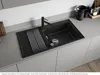 A modern kitchen sink with a black granite basin, a black faucet, and a stainless steel drying rack. Podgląd zdjęcia produktu
