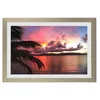 A framed picture of a sunset over the ocean with a palm tree in the foreground. Produktbild-Vorschau