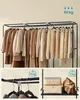 A clothing rack with various garments and a shelf with storage boxes and a bag. Náhled obrázku produktu