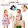 Two young girls interacting with a white rocking horse, with inset images showing a black horse and a pink saddle. Anteprima dell’immagine prodotto