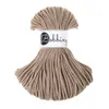 A spool of beige macrame cord with a label. Produktbild-Vorschau