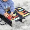 A child is playing with a busy board on a fluffy rug. Produktbild-Vorschau