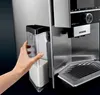 A hand is shown removing a milk container from a coffee machine. Anteprima dell’immagine prodotto
