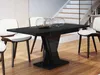 A modern dining room with a black high-gloss extendable table and white chairs, with a staircase in the background. Anteprima dell’immagine prodotto