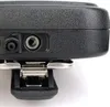 A close-up view of the side of a black electronic device, showing two ports and a metal clip attachment. Náhled obrázku produktu