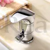 A chrome faucet is placed on a marble countertop next to a folded towel and a pink flower. Podgląd zdjęcia produktu