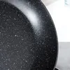 Close-up view of the speckled interior of a black frying pan. Produktbild-Vorschau