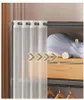 A modular wardrobe with a white sheer curtain, a stuffed animal, and a suitcase on shelves. Podgląd zdjęcia produktu