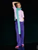 A woman posing against a black background. Produktbild-Vorschau