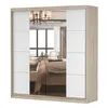 A wardrobe with mirrored doors and white panels, reflecting a bedroom interior. Voir les images du produit