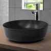 A black ceramic sink on a wooden countertop with a modern faucet and tiled wall in the background. Náhled obrázku produktu