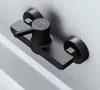 A black shower faucet mounted on a white wall. Produktbild-Vorschau
