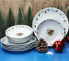 Christmas-themed tableware set with gingerbread man decorations, displayed with miniature Christmas trees and ornaments. Náhled obrázku produktu